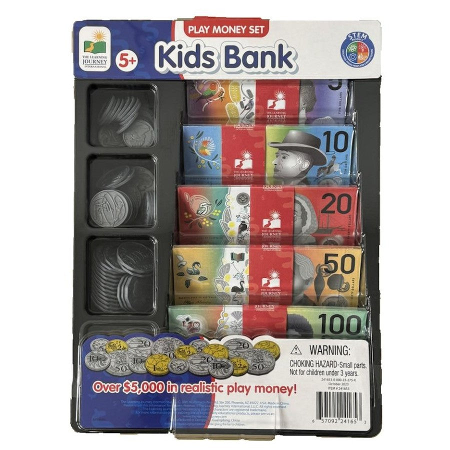 A packaged children's play money set called Kids Bank, shown in its retail blister pack. The set includes plastic coin compartments with silver toy coins and stacks of colorful play banknotes in denominations up to 100, with a printed header card and warning label.