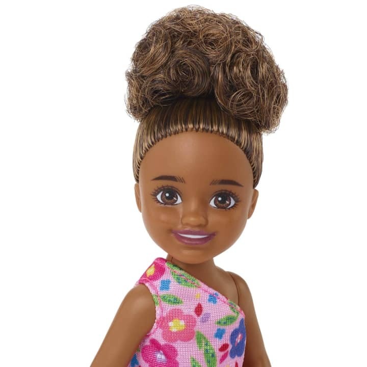 BARBIE CHELSEA DOLL (BRUNETTE CURLY HAIR) WEARING ONE-SHOULDER FLOWER-PRINT DRESS AND PINK SHOES - Toyworld Frankston