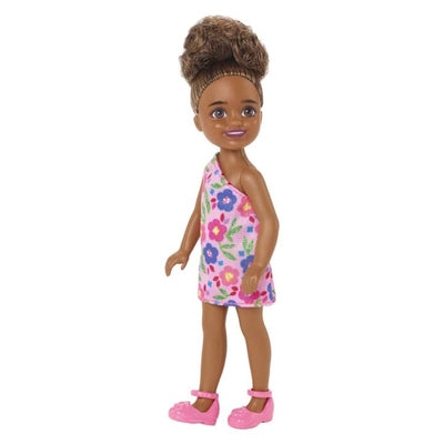 BARBIE CHELSEA DOLL (BRUNETTE CURLY HAIR) WEARING ONE-SHOULDER FLOWER-PRINT DRESS AND PINK SHOES - Toyworld Frankston