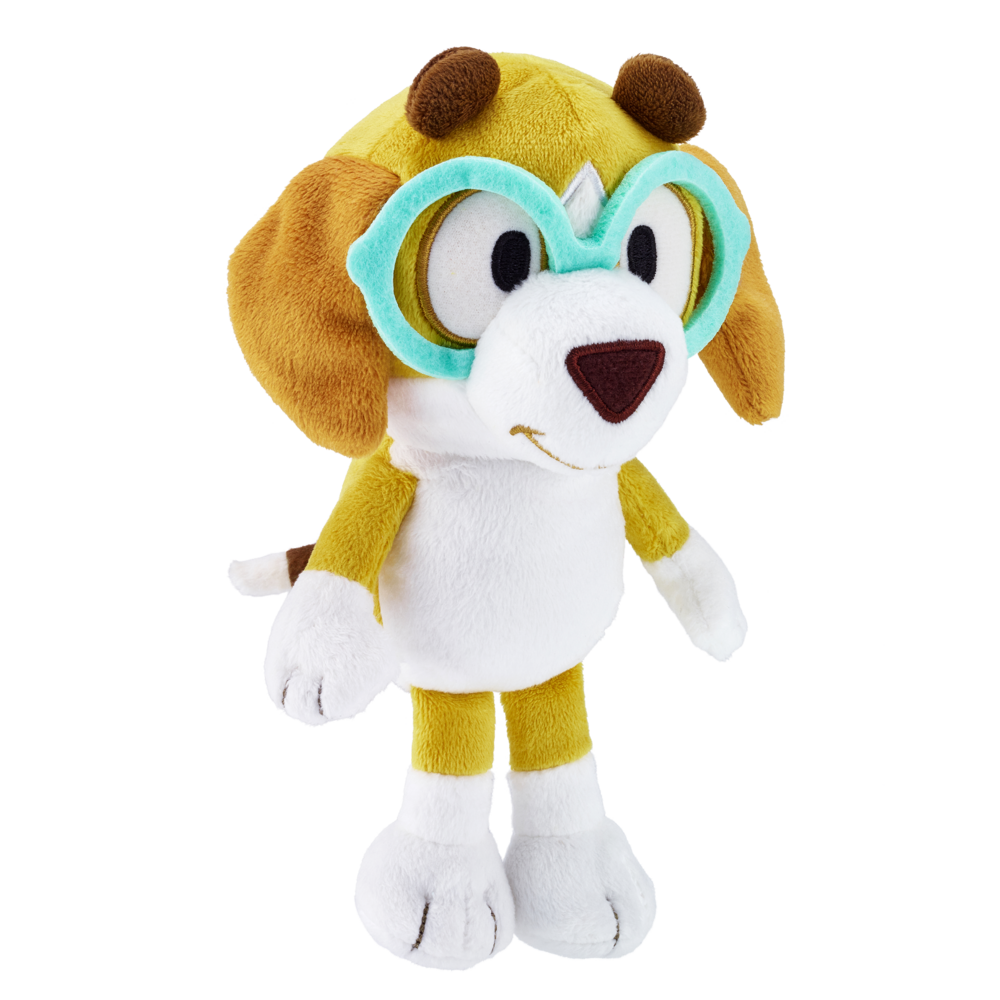 A plush toy dog character with brown floppy ears, a white face and belly, yellow arms and legs, and oversized turquoise and white goggles, shown on a plain white background.