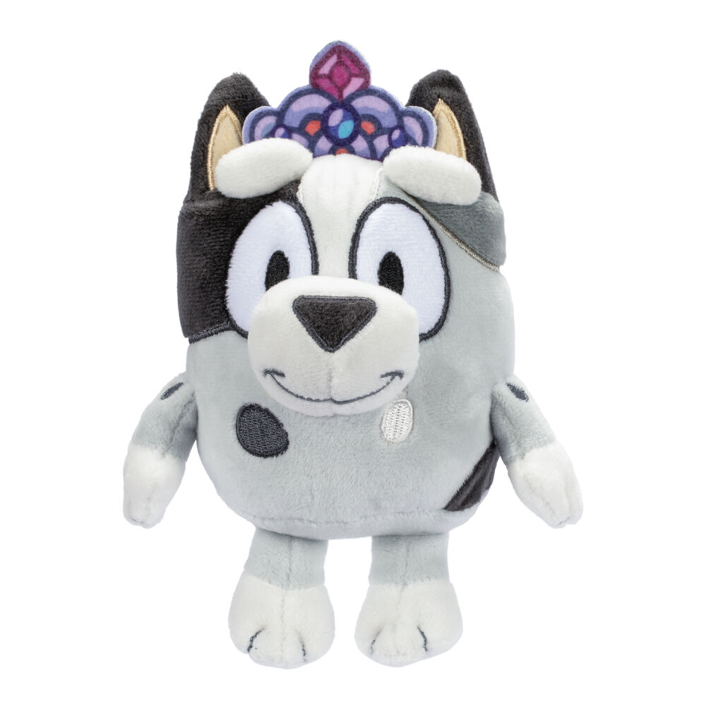 Plush toy resembling a wolf with a colorful gem on its head against a white background
