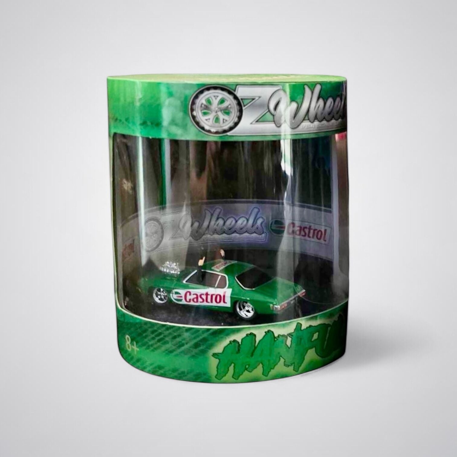 A green 1:64 scale model of a Castrol Monaro skid cylinder by OZ Wheels, packaged in a clear plastic box with the brand name and logo visible.