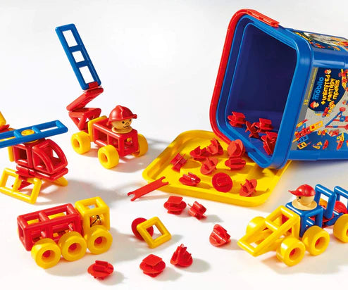 Assorted colorful Plasticant Mobilo construction set toys spilling out of a blue bucket, including geometric shaped pieces and simple mechanical models like a windmill and a helicopter.