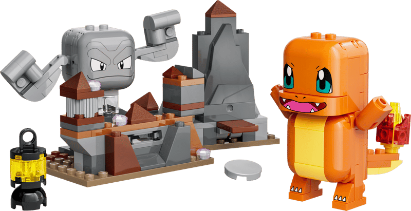 A toy building-block set featuring an orange dinosaur-like character figure with blue eyes and a yellow belly, shown beside a gray rock-and-crate structure with a small black lantern on a white background.