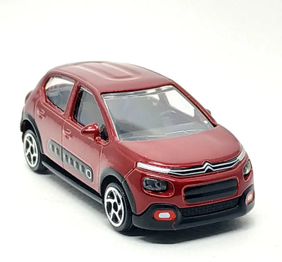 A red Citroën C2 toy car model with black plastic bumpers, wheel arches, and gray side detailing, shown on a plain white background.