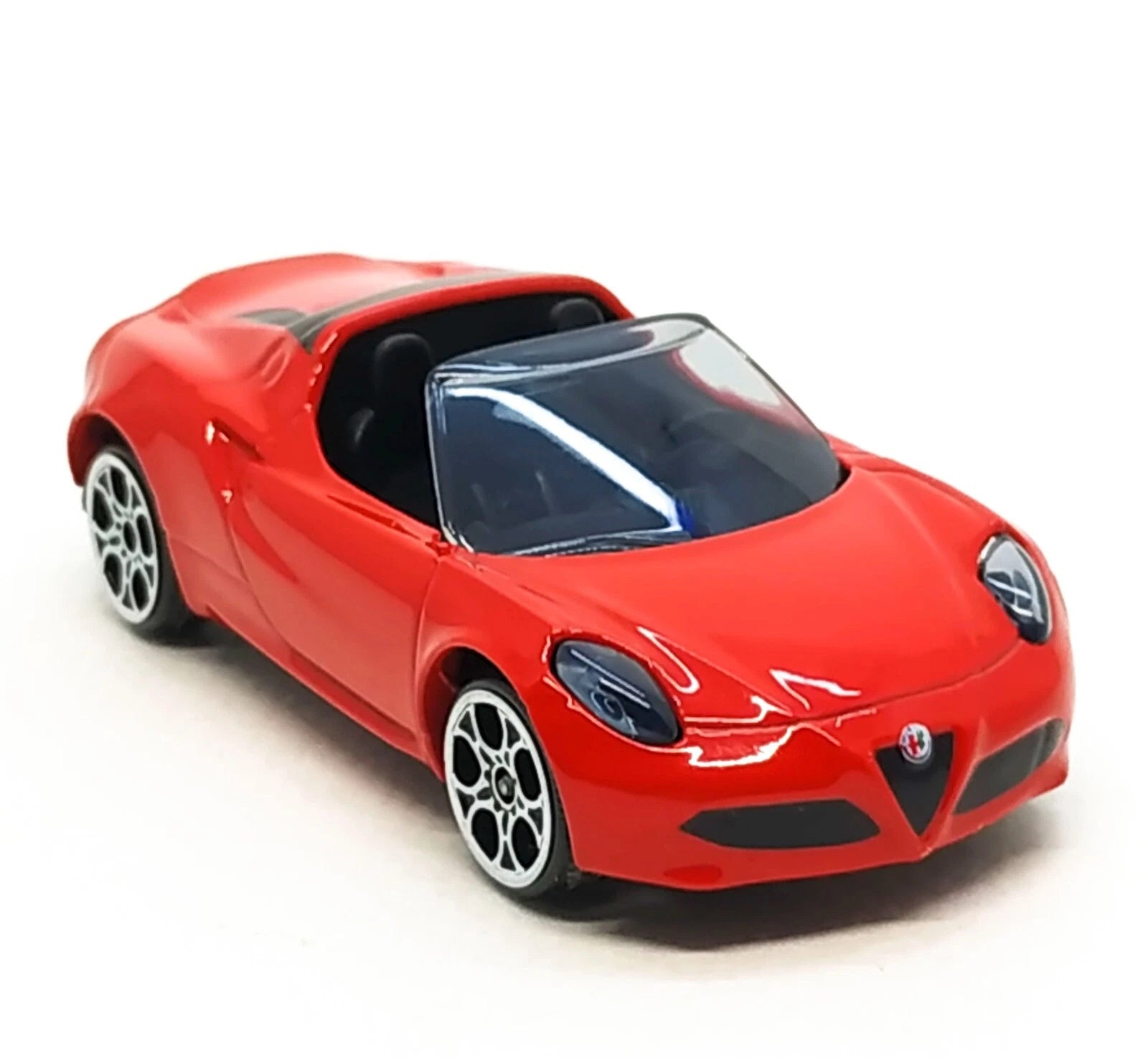 A red die-cast model car resembling an Alfa Romeo sports car, shown from a three-quarters front angle on a white background.